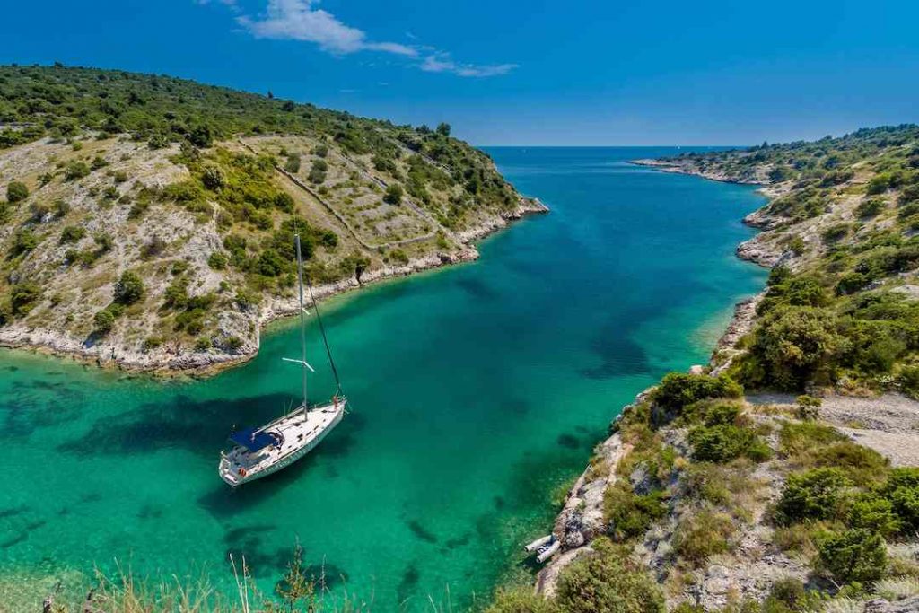 a boat sailing through a bay 