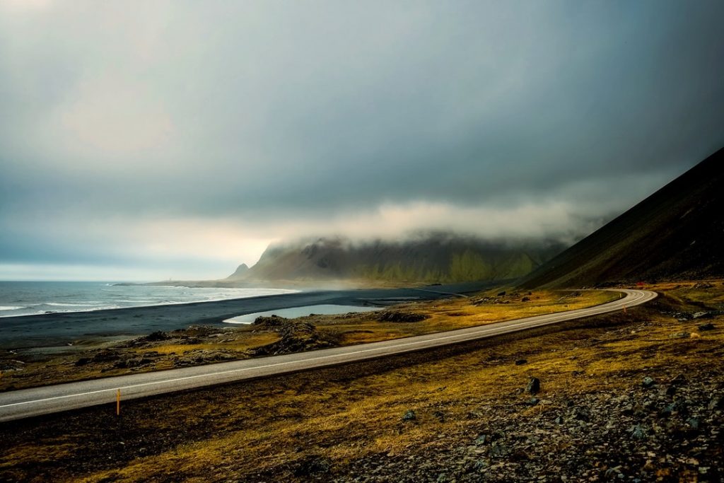 A highway snakes along Iceland's coast by the sea