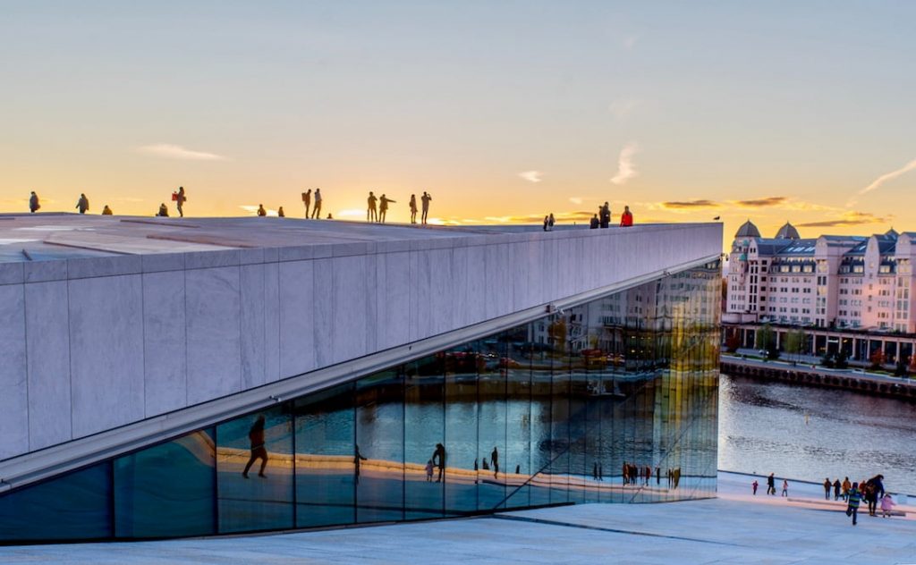 Side facing facade of Oslo Opera House at sunset