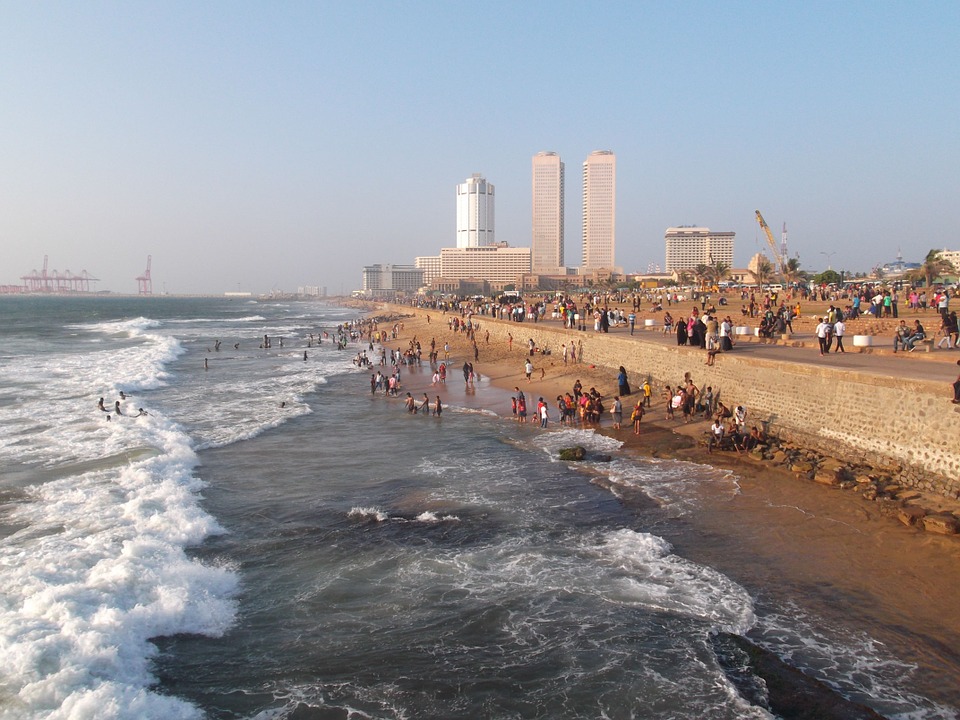 Colombo's city coastline with waves lapping up on the beach and the city scape in the background