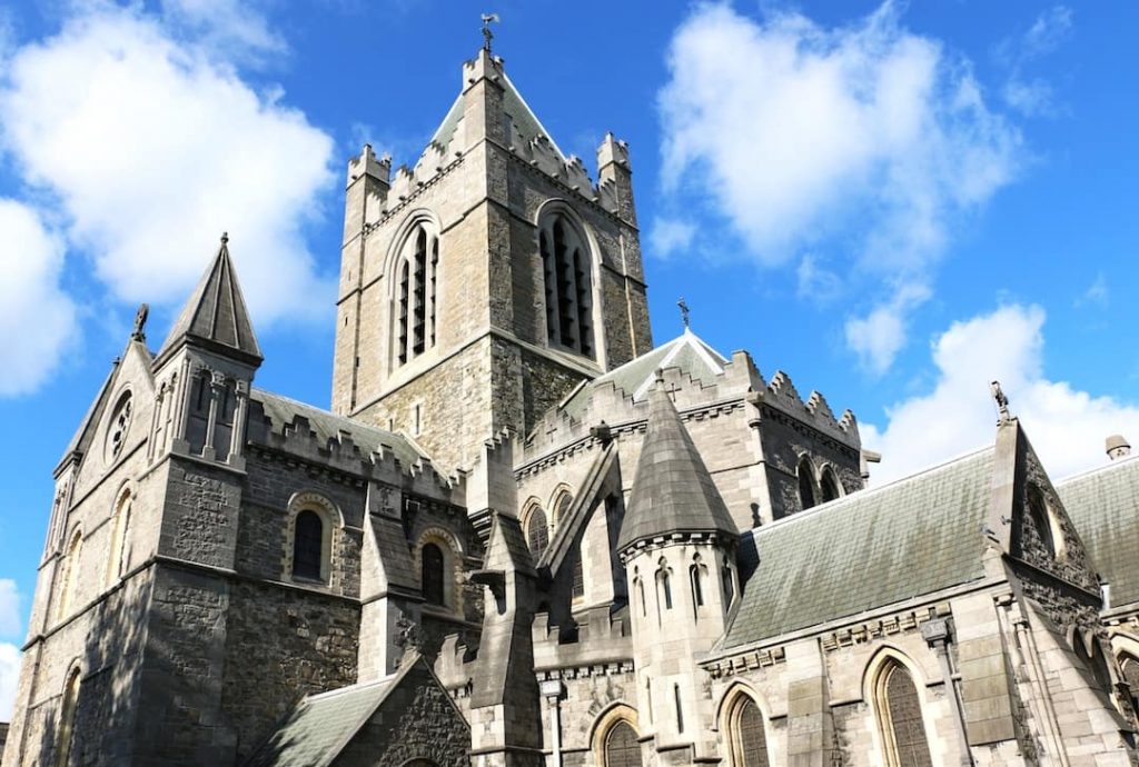 A great stone cathedral against the clouds and blue sky 