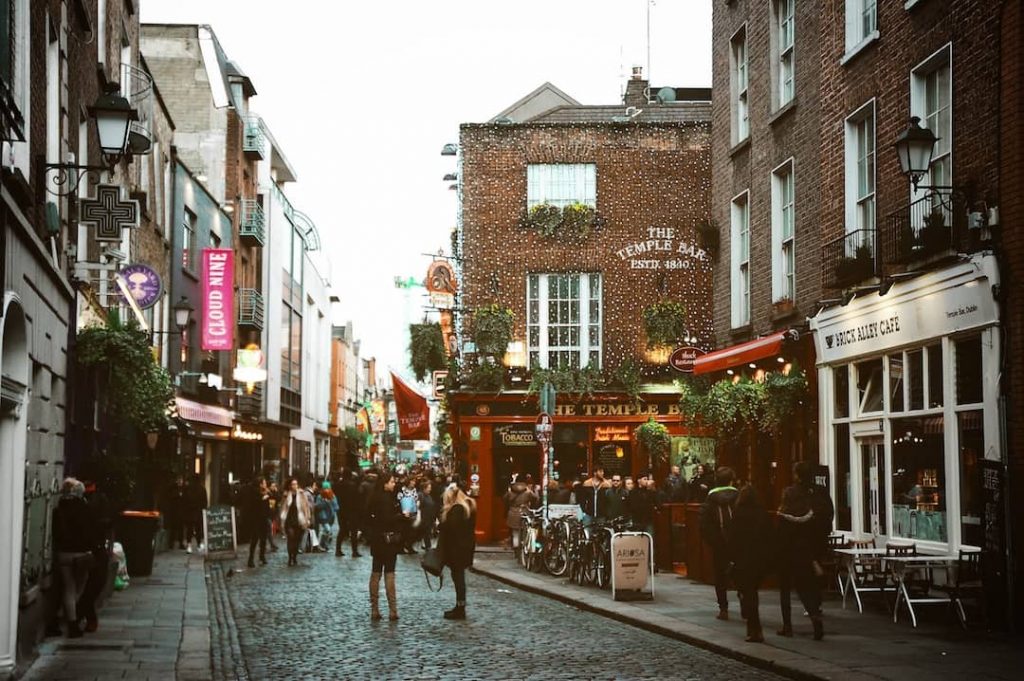 The street in Dublin where the famous Temple Bar is, people can be seen congregating along the cobbled road