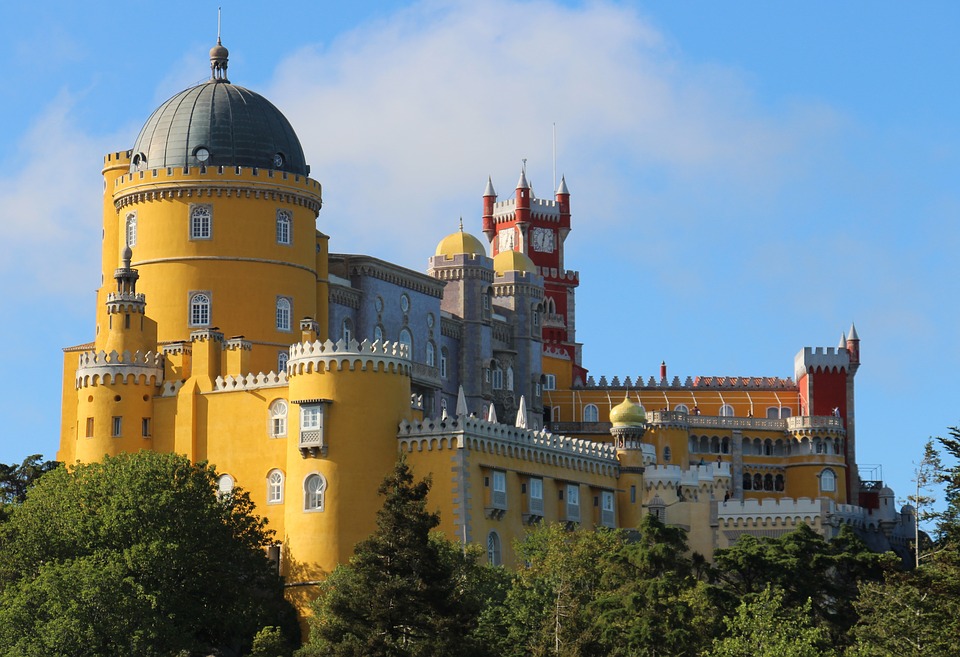 Pena Palace, a bright yellow colour palace in Sintra surrounded by trees