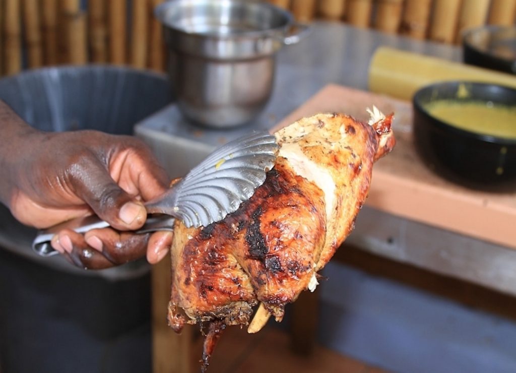 A big piece of juicy BBQ jerk chicken smothered in sauce