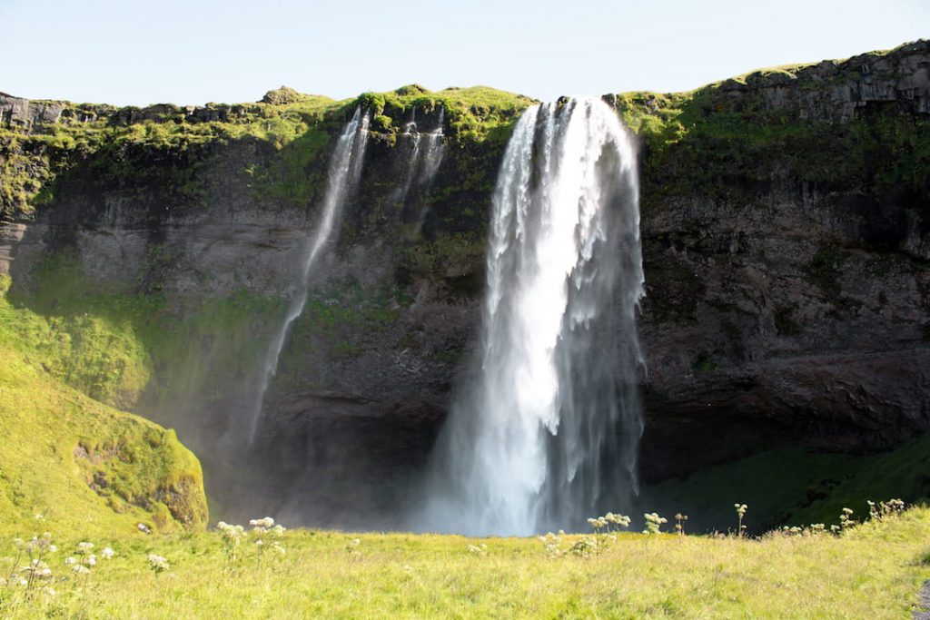 Two waterfalls rushing off a cliff in Iceland