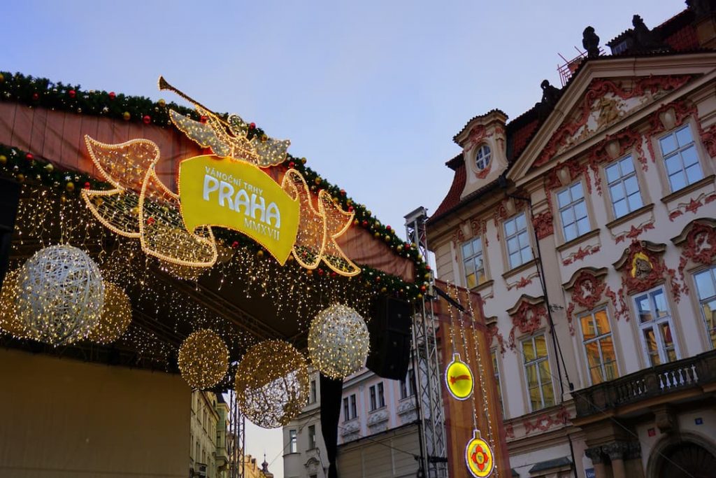 A stall with a yellow sign that says "Praha" in the Prague Christmas Market