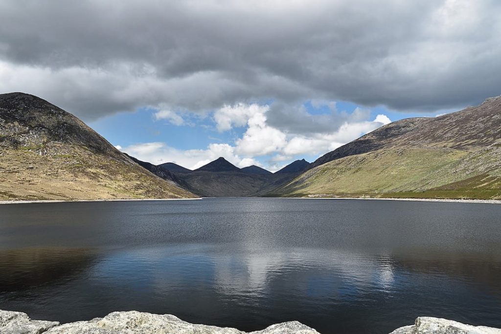 a still body of grey-blue water in a valley in Northern Ireland