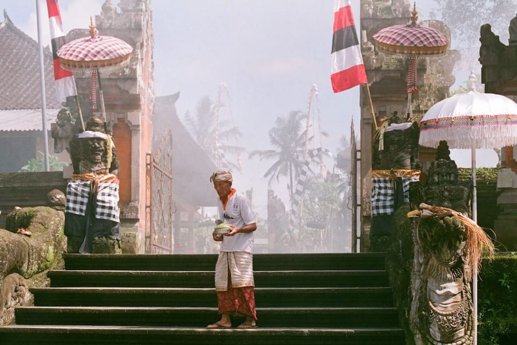 an older man stands on steps in Ubud, Indonesia