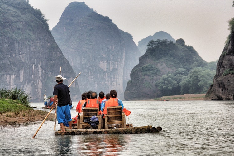 a boat with visitors sails along the dragon river