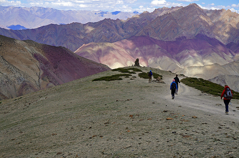 Descending Ganda La Pass , a purplish green mountain trail in India