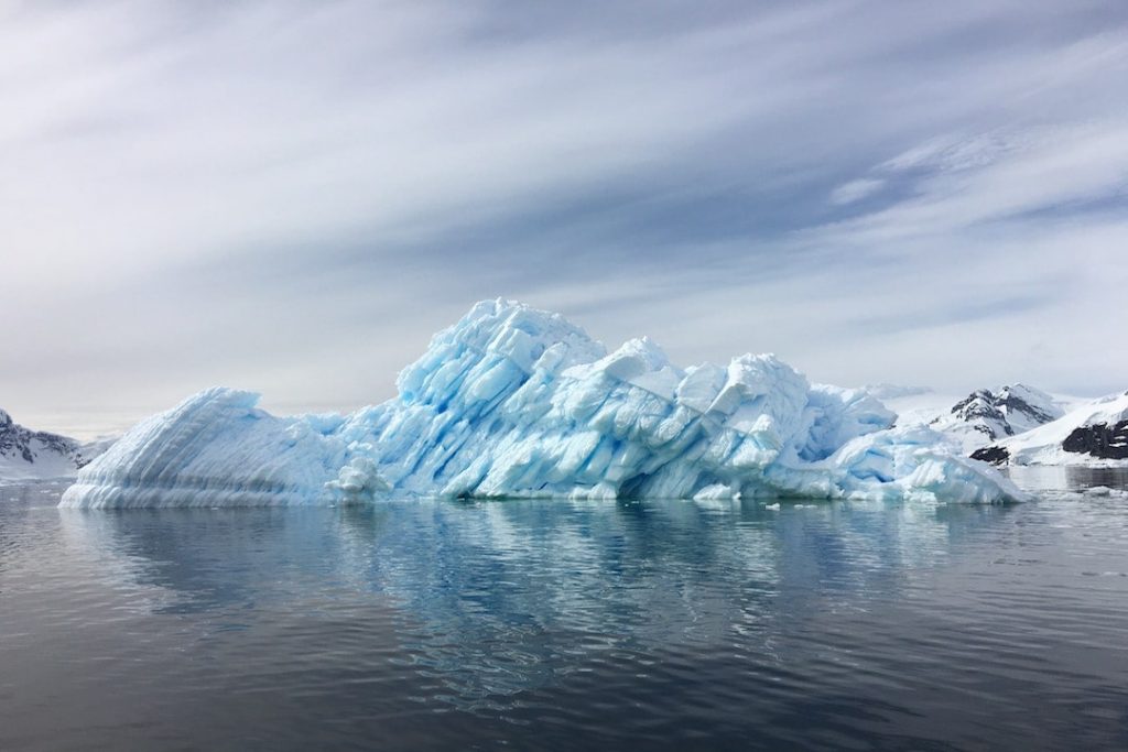 a large iceberg jutting out of the water in antarctica