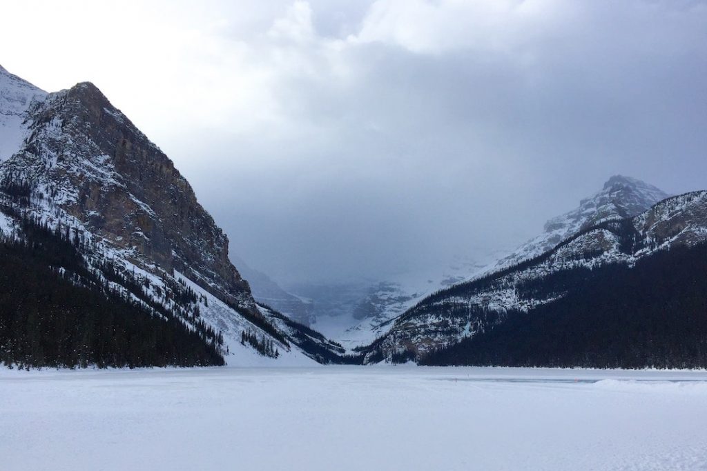 A picture of the frozen Lake Louise in Alberta on a cloudy day