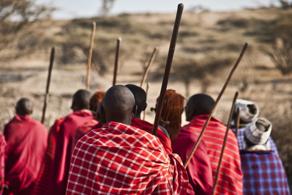 A group of Maasai people in Tanzania wearing red cloaks