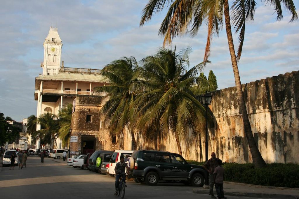 an old building and palm trees in Stone Town, Tanzania