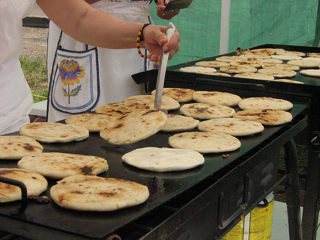 A person cooking pupusa, traditional food of El Salvador