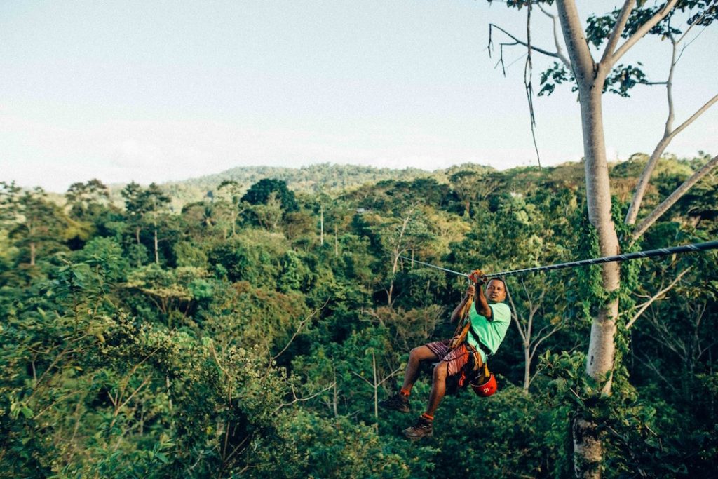 A person ziplining across the trees in Costa Rica