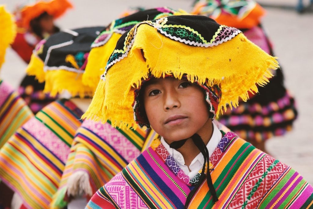 A young person dressed in traditional outfit in Cusco Peru