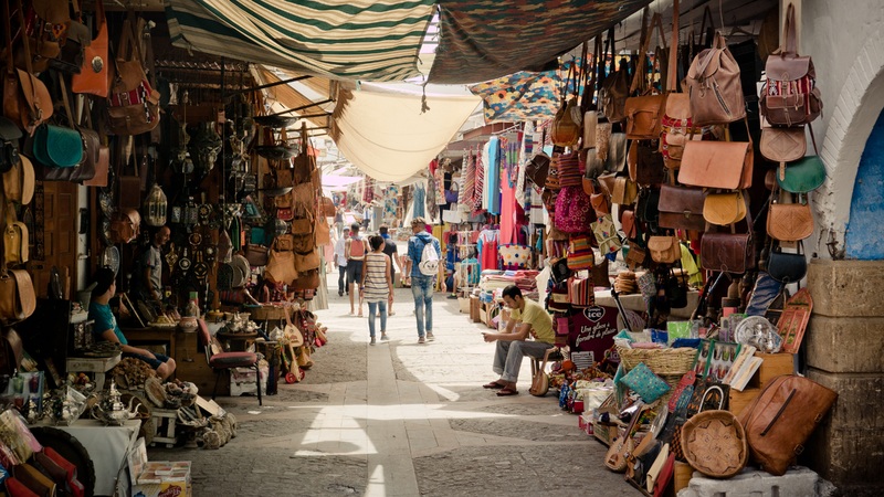 a market alleyway laden with leather goods