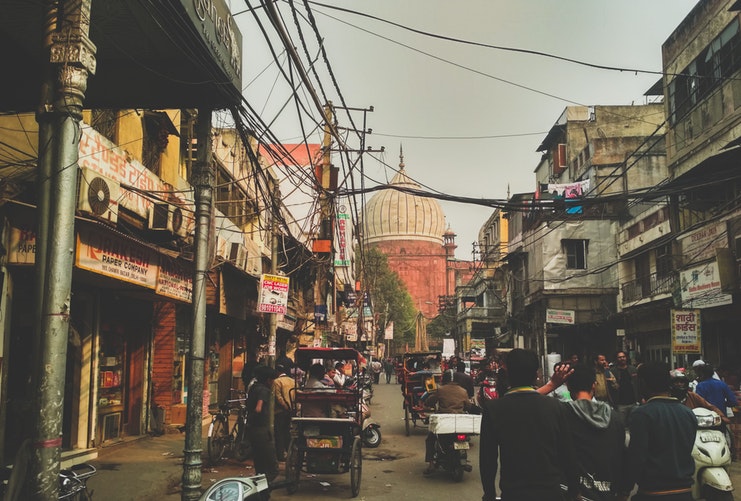 a bustling city in the Delhi filled with traffic and people