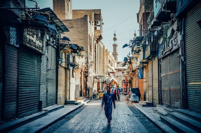 A man walking down an alley in Cairo, Egypt