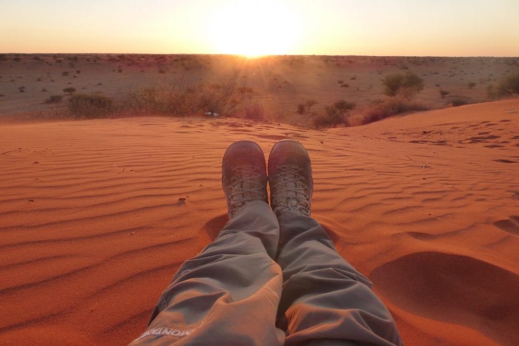 A photo of a person's legs in the desert in Namibia