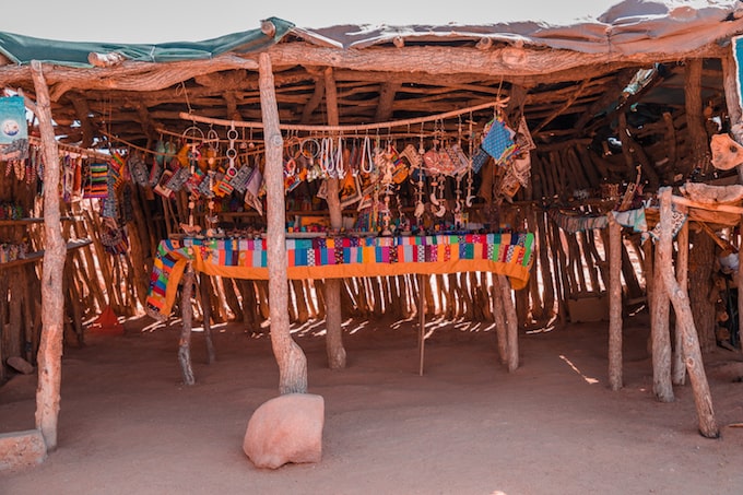 A market stall selling necklaces, dolls, and other products in Swakopmund, Namibia