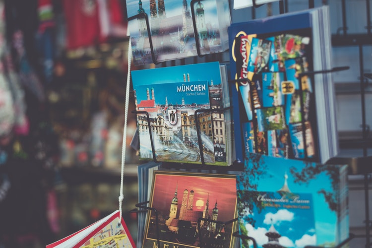 close-up of colourful postcards on a rack