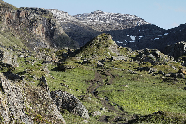 a green valley landscape with giant rock formations