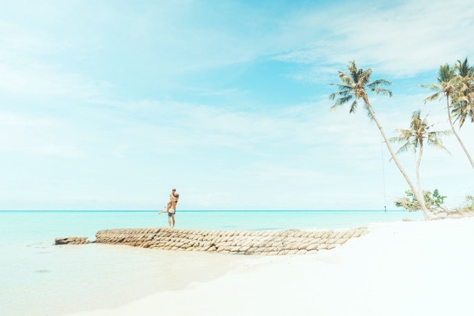 A couple hugging on a beach in the Maldives