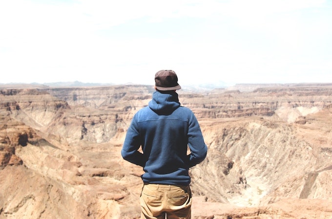 A man sanding above a canyon in Namibia