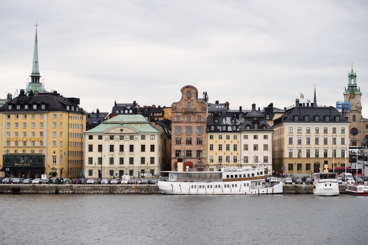 shot of river with colorful buildings along the bank