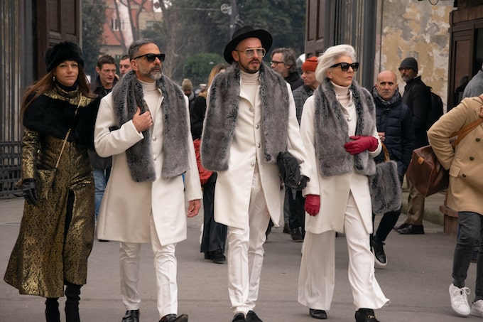 Three people in white suits in Florence, Italy