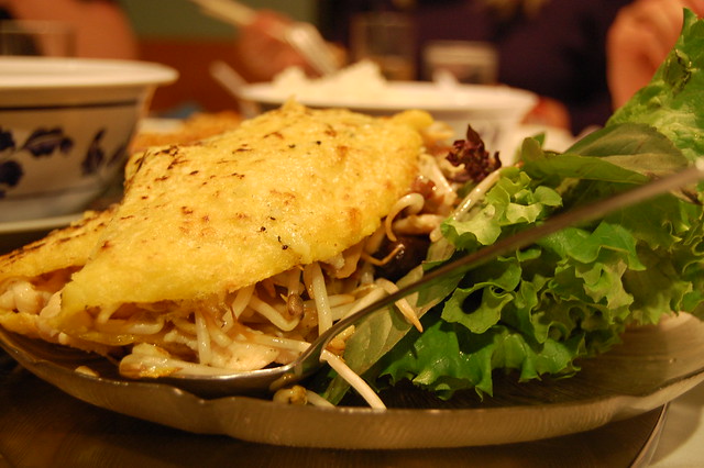 a yellow omelette type of crepe stuffed with filled