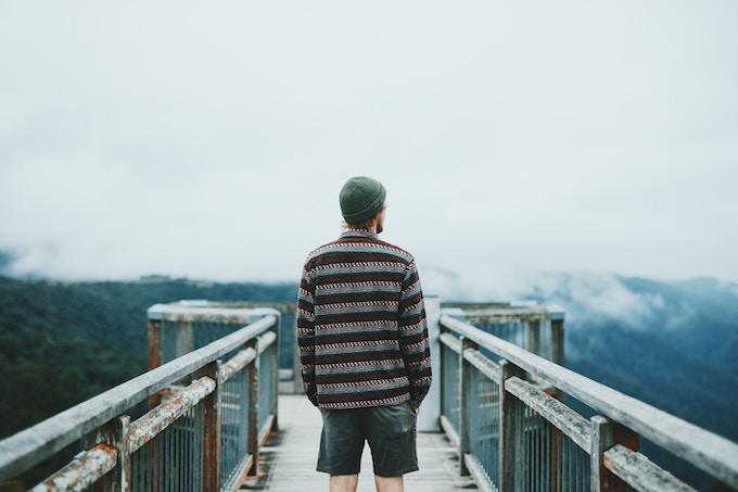 A man standing on a bridge