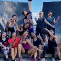 a group of people posing after a workout