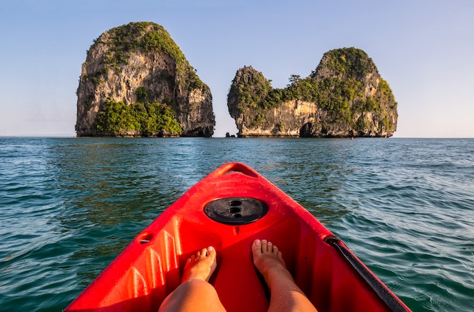 A person relaxing in a red kayak in Krabi, Thailand