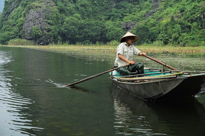 A person rowing a boat in Tam Coc, Vietnam