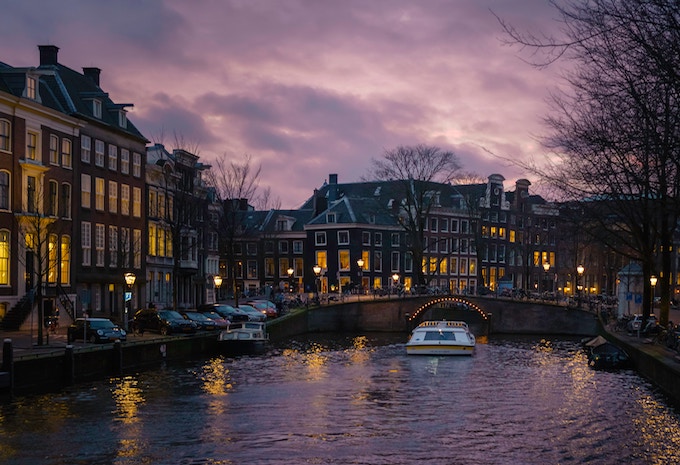 a boat going through a tunnel on a canal in amsterdam