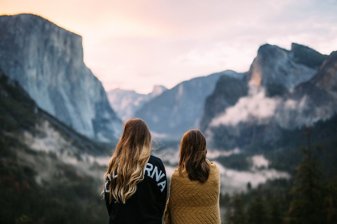 Two girls standing beside each other near El Capitan in Yosemite National Park