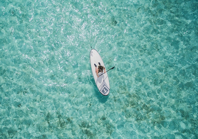 a woman paddle boarding