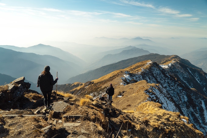 A person standing on the top of a mountain