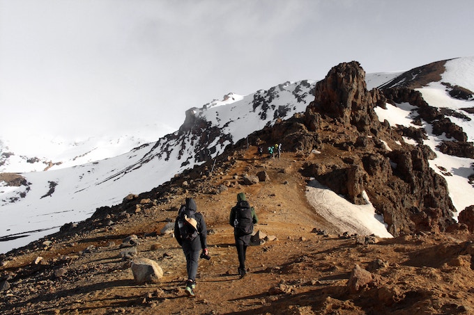 Two people hiking in Tongariro National Park, New Zealand