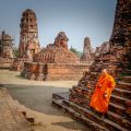 A monk walking down a temple in Ayutthaya, Thailand