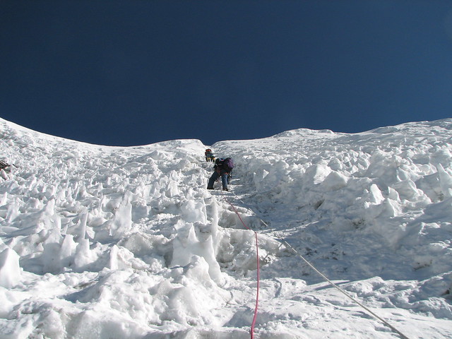 a climber uses fixed ropes through ice