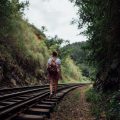 A girl walking alone on train tracks in Sri Lanka