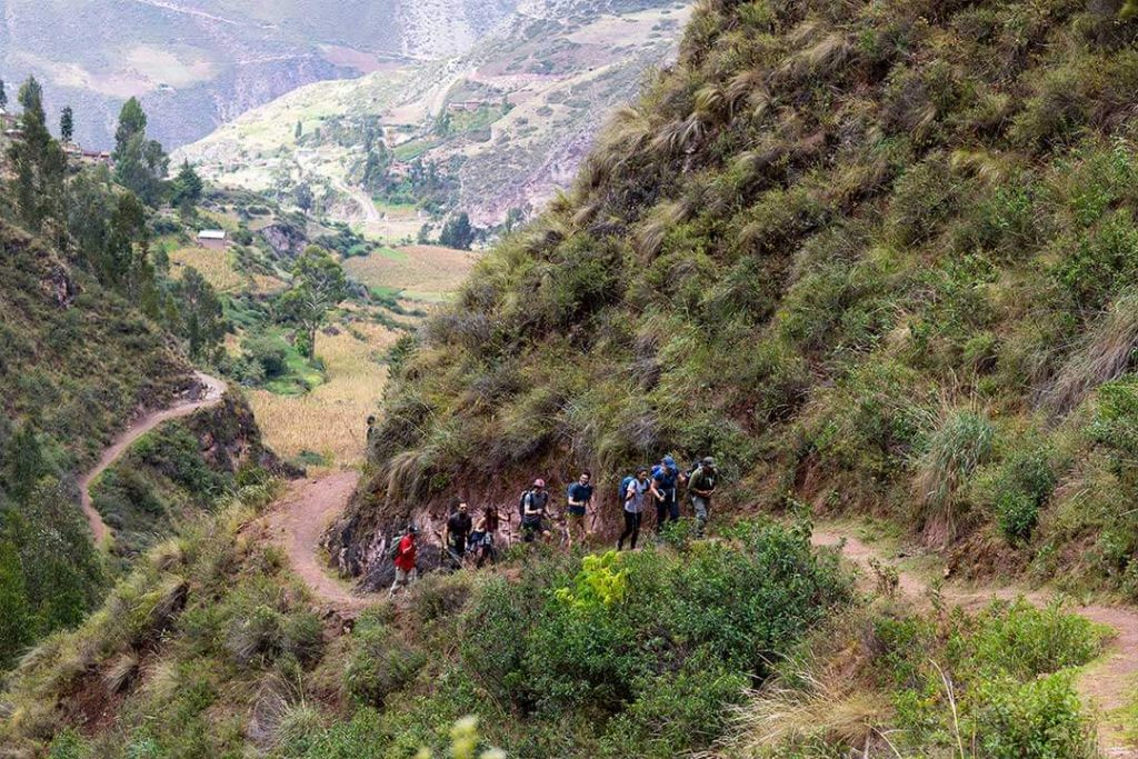 a group of trekkers walking along a ridge in the andes