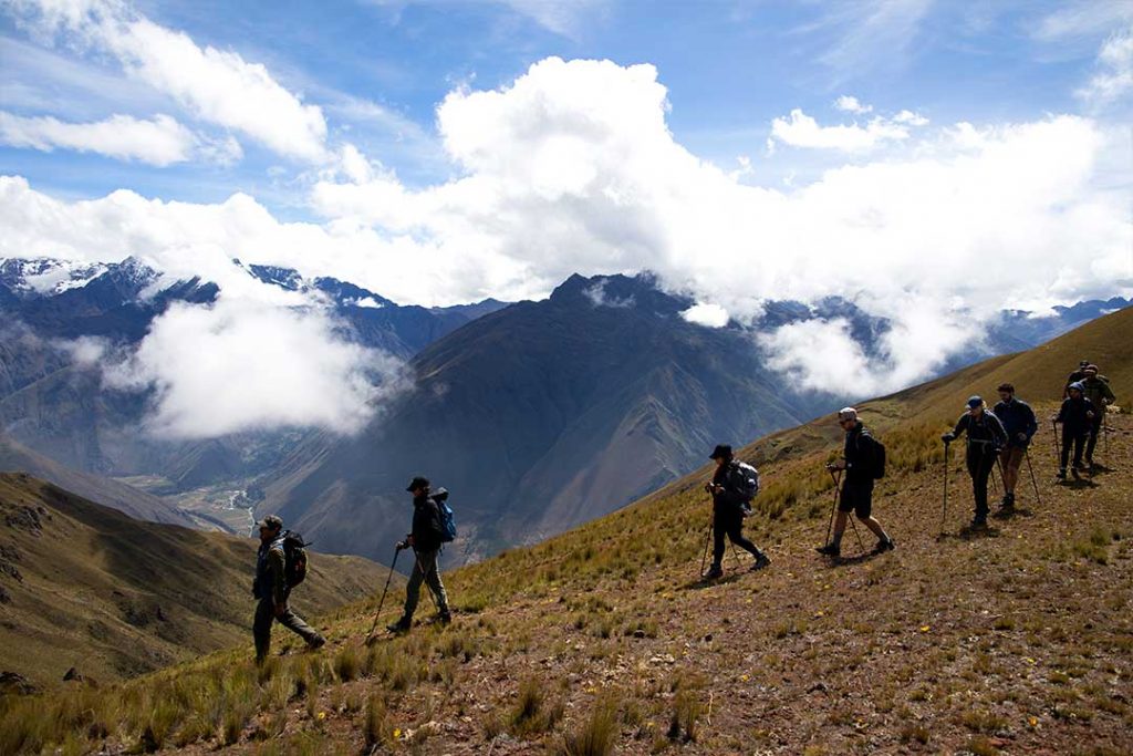 a group of trekkers walking along a ridge in the andes