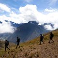 a group of trekkers walking along a ridge in the andes