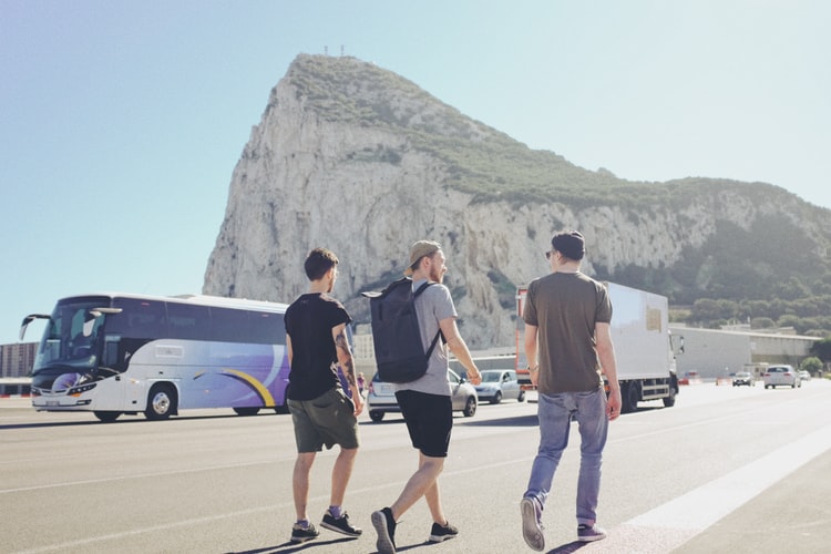 three guys walking along the road