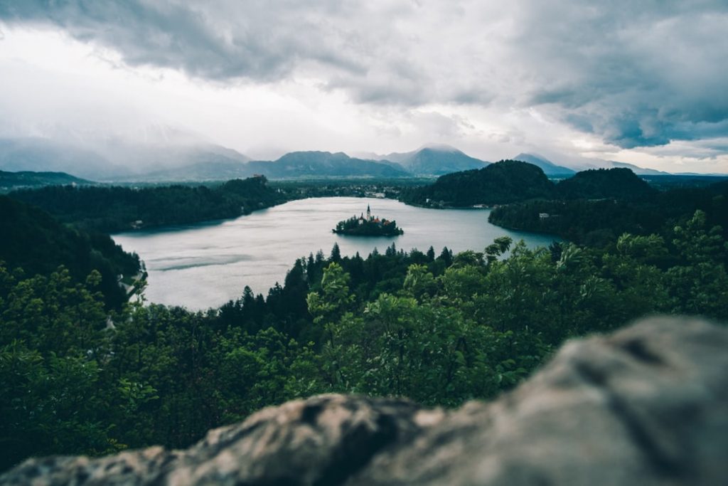 high-angle photography of lake surrounded by trees